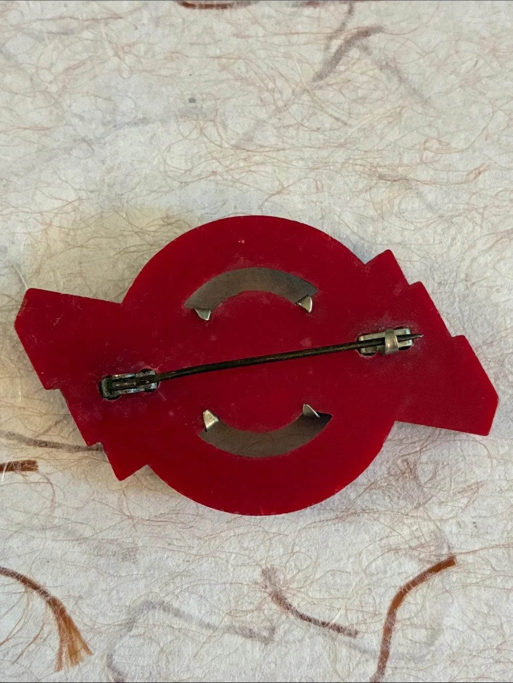 Machine Age Art Deco red Bakelite brooch with chrome overlay